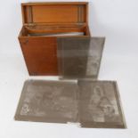 A mahogany case, width 33cm, with brass handle, containing glass photographic slides