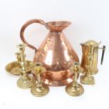 An early 19th century large copper ale measure, turned brass candlesticks, Arts and Crafts brass