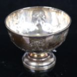 An Edward VII silver bowl on foot, with ribbon and bow embossed decoration, H7.5oz, Sheffield