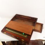 A large 19th century brass-bound mahogany writing slope, with secret drawer and recessed handles,