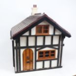 A Vintage Tudor style doll's house, with some fittings, height 57cm