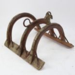 Part of a camel's saddle harness, in wood, iron and embossed brass, length 53cm
