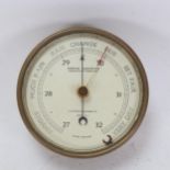 A brass-cased aneroid barometer, by Reynolds, Son & Wardale, 13cm