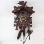 A Vintage Black Forest oak cuckoo clock, with pine cone weights, clock height 45cm