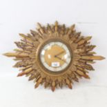 A Vintage gilded sunburst quartz wall clock, overall width 56cm, working order