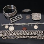 A tray of silver jewellery, to include an engraved and embossed bangle, silver Alberts, bracelets