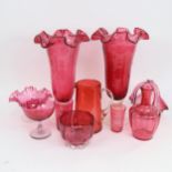 A pair of cranberry glass vases with wavy rims, a jug, 18cm, and other cranberry glassware