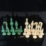 A 19th century Indian Pepys pattern part chess set, green stained and white carved ivory pieces,