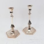 A pair of Art Deco silver plate on bronze table candlesticks, height 24cm