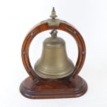 A gong in carved oak horseshoe design stand, lacking striker, height 29cm