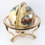 A reproduction hardstone desk terrestrial globe, on gimballed brass stand, diameter approx 30cm