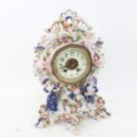 A large Vintage Continental porcelain-cased 8-day mantel clock, with applied figures and flowers,