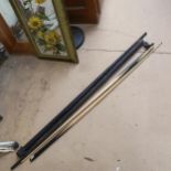 2 snooker cues, in black painted aluminium travelling cases