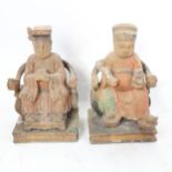 A pair of Chinese painted plaster seated Emperor and Empress figures, height 26cm