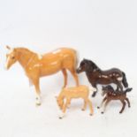 A Beswick Palomino and foal, Beswick Shetland pony, and a Bay foal