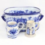 A reproduction blue and white transfer printed foot bath, a Continental mug, and a Doulton mug