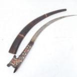 A Persian metal inlaid hardwood curved sword and scabbard, blade length 35cm