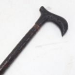 An Antique Eastern carved hardwood sword stick, blade length 41cm