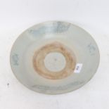 A Chinese glazed stoneware pottery dish, with blue phoenix decoration, 28.5cm