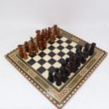 A turned wood chess set, on board with inlaid decoration, King height 9.5cm