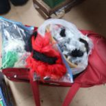 A large travel bag, containing costume decorations, feathers, miniature bells etc