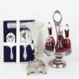 A plated condiment stand with engraved red glass bottles, height 39cm, epergne in stand, and a brush