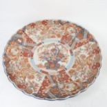 A large 19th century Japanese Imari style charger, hand painted and gilded floral decoration, with