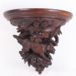 A Black Forest carved wood dog wall bracket, H32cm, W36cm