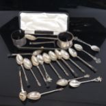 A cased silver baby's food pusher and spoon, 2 silver napkin rings, 5 silver teaspoons with