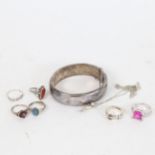 A group of silver jewellery, to include an engraved hinged bangle, 4 stone set rings, buckle ring