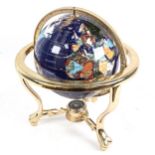 A reproduction brass and hardstone table-top terrestrial globe, with compass inset base, overall