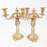A pair of 19th century French Louis XV ormolu and porcelain twin-branch candelabra, hand painted