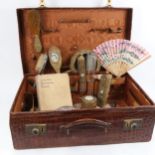 A crocodile skin suitcase, 56cm, containing Vintage dressing table items etc