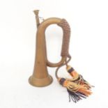 A First World War Period brass bugle, with rope tassels
