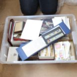 A large boxful of postage stamps, including Jersey First Day Covers, Mint, and loose stamps