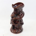 A treacle-glaze snuff taker Toby jug, height 25cm