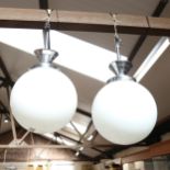 A pair of chrome-mounted ceiling lights, with globular milk glass shades, diameter 21cm