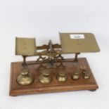 Victorian brass postal scales, on mahogany stand, with weights, largest 1/2 lb