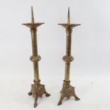 A pair of 19th century French brass Gothic church pricket candlesticks, with fleur de lis stems,