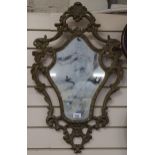 An ornate wall mirror with shaped edge, height 74cm