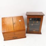 An oak smoker's cabinet with glazed door, and a desk-top stationery rack with drawer under, height