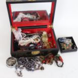 A lacquered jewel box, containing a quantity of mixed costume jewellery, to include a panther