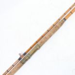 A Vintage split cane fishing rod, with brass mounts and cork handle, overall length 250cm