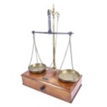 Victorian brass balance scales, on mahogany base with drawer under and weights, by V H Marsden &