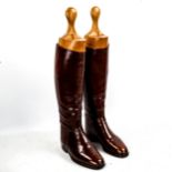 A pair of early 20th century brown leather riding boots, with original shoe trees