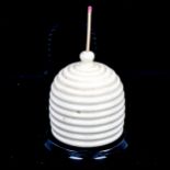 A white glazed ceramic beehive design Go To Bed match holder with striker, height 8cm