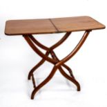 A Victorian mahogany folding coaching table, on X-framed base