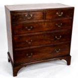A George III mahogany square chest of drawers, with original brass drop handles and bracket feet,