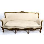 An ornate Continental carved giltwood-framed salon sofa, with shaped serpentine front, recently re-
