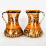 A good pair of art deco striking jugs made by Myotts circa 1920 in rich orange and black enamels